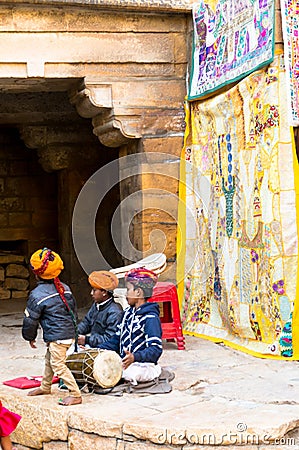 Children in Rajasthani dress playing a drum Editorial Stock Photo