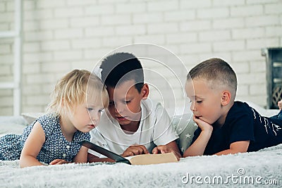 A children read a bible on the bed Stock Photo