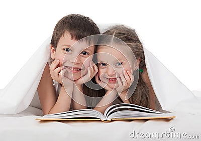 Children read a book in bed Stock Photo