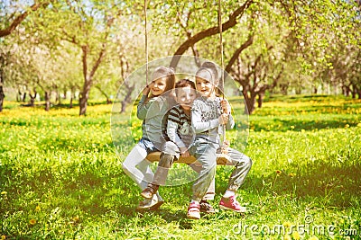 Children rest on a swing Stock Photo