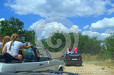 Children riding in cars on dirt road Editorial Stock Photo