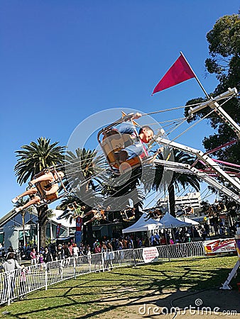 Children riding fast spinner @ Granny Smith Festival Editorial Stock Photo