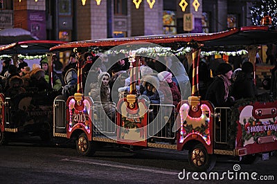 Children riding the pleasure train for excursions on the evening street. Kyiv, Ukraine Editorial Stock Photo