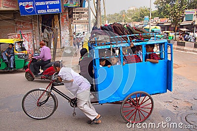 Children riding to school with cycle rickshaw, Delhi, India Editorial Stock Photo