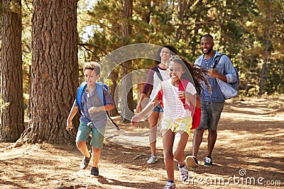 Children Running Ahead Of Parents On Family Hiking Adventure Stock Photo