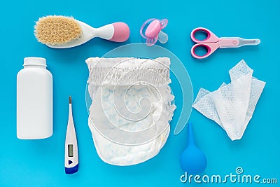 Children`s accessories and cosmetics on a blue background, flat lay, top view, layout. The concept of hygiene of the baby. A set Stock Photo