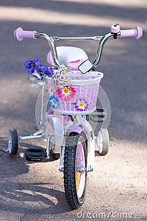 Children`s color four wheel bicycle with flowers Stock Photo