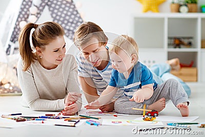 Children`s creativity. happy family mother father and son draw Stock Photo