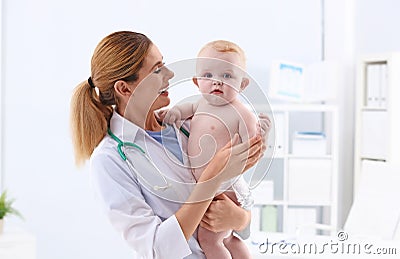 Children`s doctor with cute baby in hospital Stock Photo