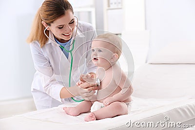 Children`s doctor examining baby with stethoscope Stock Photo