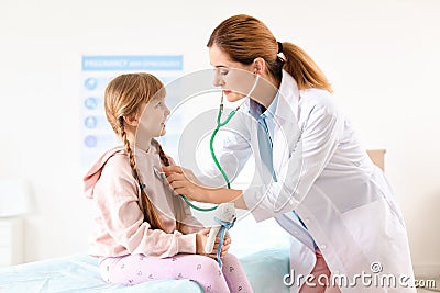 Children`s doctor examining little girl in hospital Stock Photo