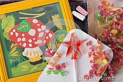 Children's drawing plasticine mushroom amanita autumn still life on a table board crayons candy lollipop Stock Photo