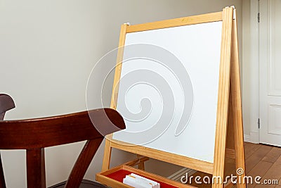 Children`s easel for painting in a bright room Stock Photo