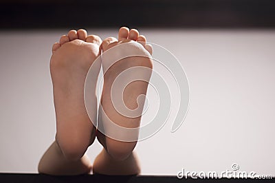 Children`s feet. Bare feet. Foot of the child. Stock Photo