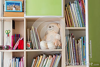 Children's furniture with bookshelves, books and teddy bear Stock Photo