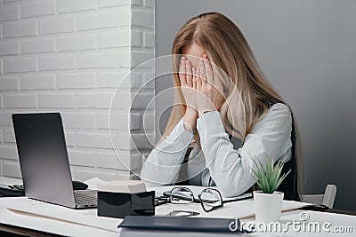 Tired, tortured business lady loaded with end-of-day work Stock Photo