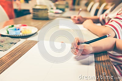 Children`s hand prepare drawing on art class. Vintage film filte Stock Photo