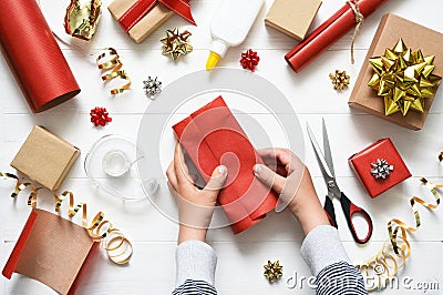 Children`s hands of a boy are wrapping a gift. View from above. Step by step photo. Step Four Stock Photo