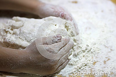 Children`s hands and dough. Little boy kneading a dough. Healthy handmade food concept. bakery products, pizza, flour. cooking Stock Photo