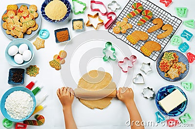 Children`s hands roll ginger dough with Gingerbread cookies and Stock Photo