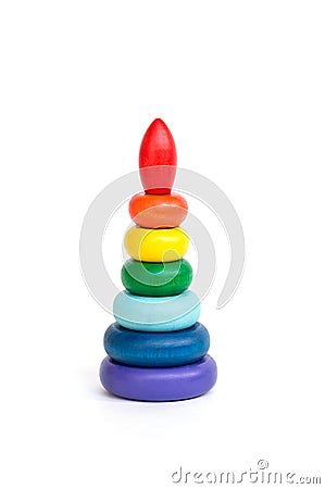 Children`s multi-colored wood toy pyramid isolated on white background. Assembled Pyramid Stock Photo