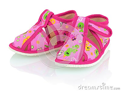 Children`s pink slippers on the white background with shadow reflection. Stock Photo