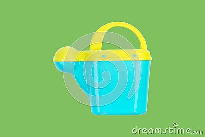 Children's plastic watering can for playing in the sandbox or in the garden. Stock Photo