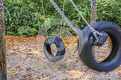 Children`s playground in Germany - view to two tire swings Stock Photo