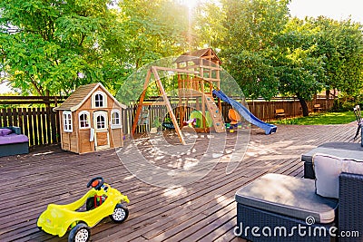 Children's playground on a wooden terrace near a country house or a summer hotel Editorial Stock Photo