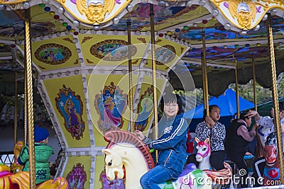 Children`s playground, merry-go-round, little girl. Editorial Stock Photo