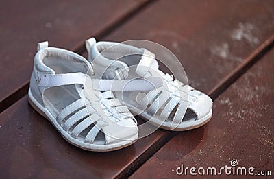 Children`s sandals on the boardwalk Stock Photo