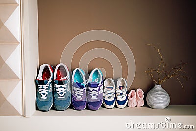 Children`s shoes next to an adult Stock Photo