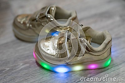 Children`s shoes on a wooden surface Stock Photo