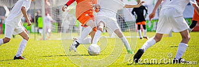 Children`s soccer drills. Kids kicking football match on pitch Stock Photo