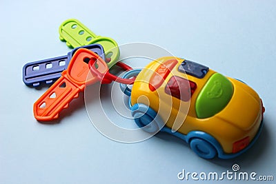 Children`s toy car with keys. Toy keychain from the car. Multi-colored key with keychain. Stock Photo