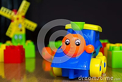 children`s train on wooden table surrounded by toys Editorial Stock Photo