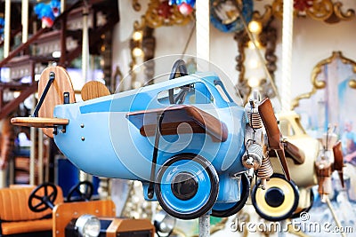 Children`s vintage blue plane. Children`s carousel. Kids toys. Little pilot. Retro plane.old plane, biplane. Aviation Day. Stock Photo