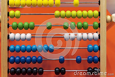 Children`s wooden abacus on an orange background Stock Photo