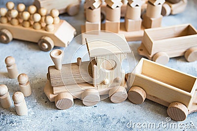 Children`s wooden toys. Children wooden train with wagons and cars. Natural wood construction set Stock Photo