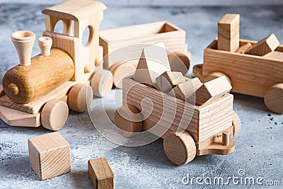 Children`s wooden toys. Children wooden train with wagons. Natural wood construction set. Educational equipment Stock Photo