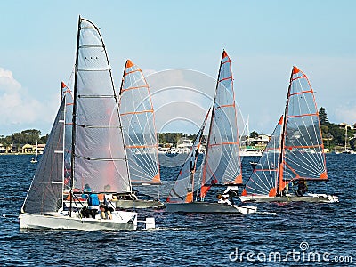 Children Sailing, class racing in 29er dinghies in a high school Editorial Stock Photo