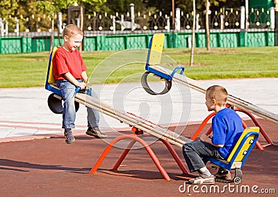 Children on a seesaw Stock Photo