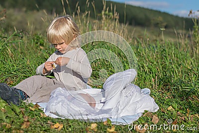 A blond boy with younger newborn brother Stock Photo