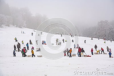 Children are skating at a toboggan run in winter Editorial Stock Photo