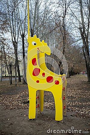 Children slide on the playground in the form of a giraffe. Stock Photo