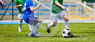 Children Soccer Players Running with the Ball. Kids in Blue and Green Shirts Editorial Stock Photo