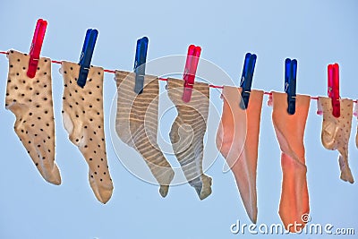 Children socks on clothesline outside Stock Photo