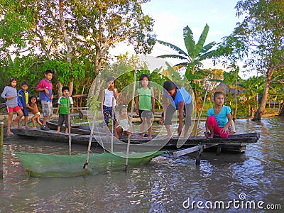 Children standing on pier by river Editorial Stock Photo