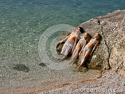 Children sunbathing at sea Stock Photo