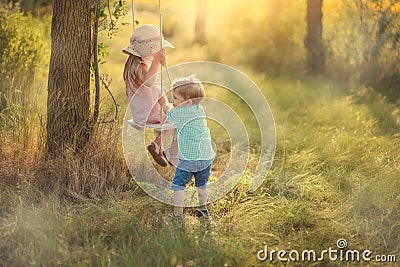 Children on a swing Stock Photo